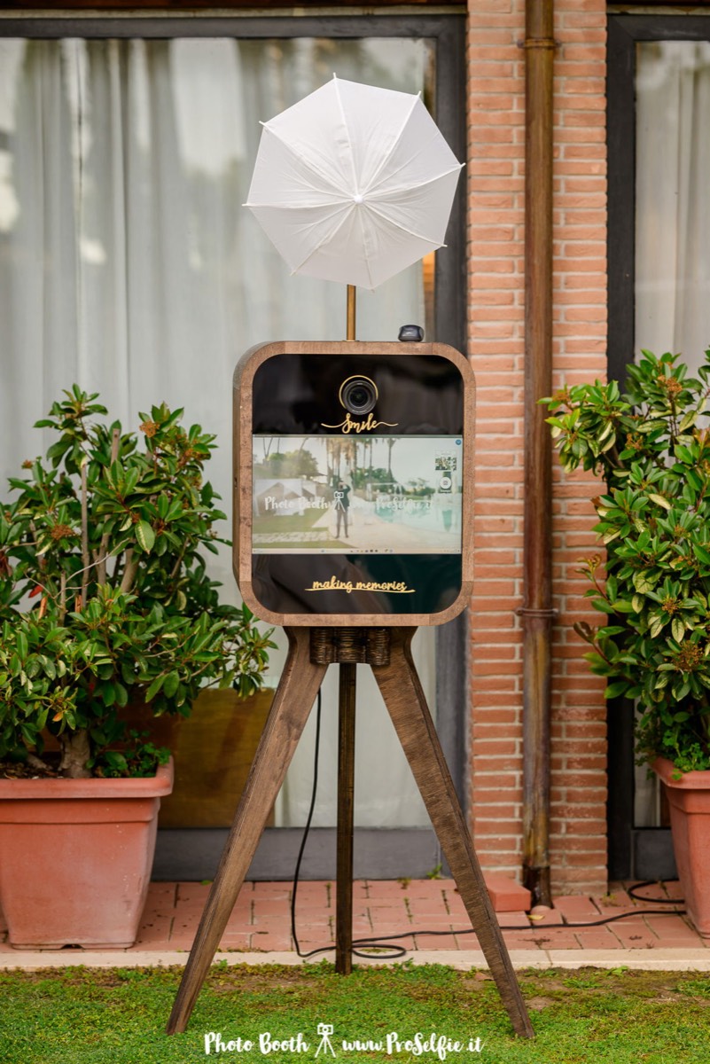 Guests using the photo booth during a wedding reception